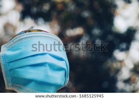 Close up globe wearing surgical mask, world health day, medical and healthcare, global pandemic, social distancing, 2019-ncov risk and problem, coronavirus covid-19 warning concept