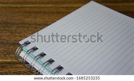A notebook on wooden background