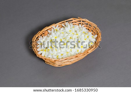 Basket with flower petals on gray background.high resolution photo.