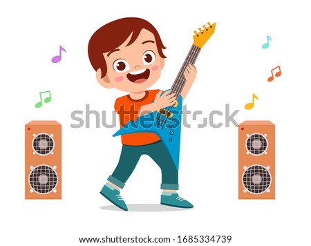 happy cute little kid boy play guitar