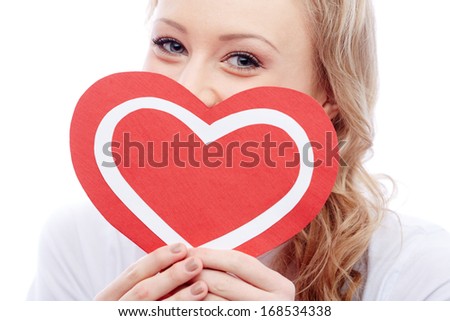 Portrait of young woman holding paper heart