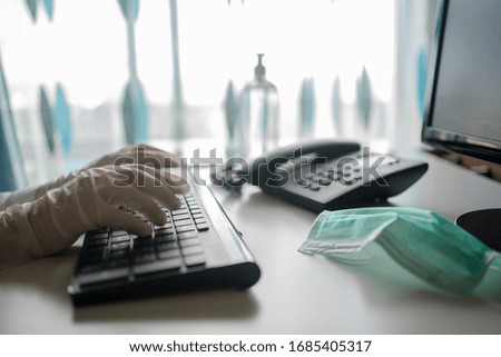 Close up on hands in medical gloves typing on keyboard. Protective care. Emergency problem. Healthcare employee practitioner, distance working and learning concept. Modern technology background