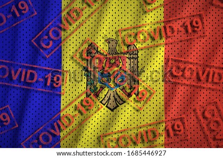 Moldova flag and many red Covid-19 stamps. Coronavirus or 2019-nCov virus concept