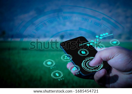 Hand of business man use smart phone in farm, futuristic ai technology, Internet of things, social media and big data concept,  Digital farm analysis and report, hologarphic interface