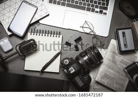 Flat lay composition with equipment for journalist on grey table Royalty-Free Stock Photo #1685472187