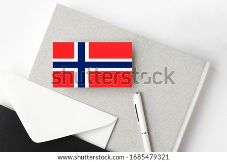 Bouvet Islands flag on minimalist letter background. National invitation envelope with white pen and notebook. Communication concept.