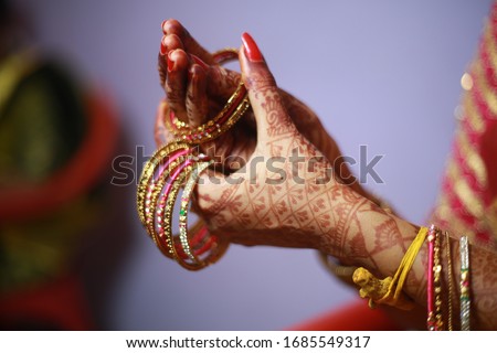 indian bride bangles getting ready for wedding Royalty-Free Stock Photo #1685549317
