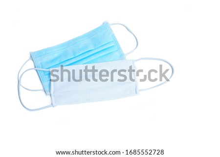 Blue medical mask or surgical face mask with non medical cloth mask to prevent from covid19 or Coronavirus infection on white background Royalty-Free Stock Photo #1685552728