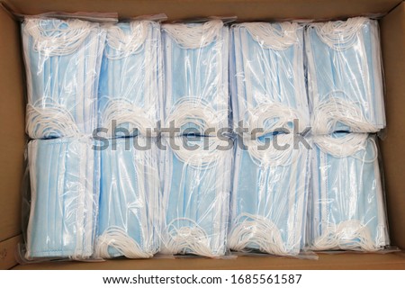 Due to the shortage of medical supplies due to the Coronavirus COVID-19 epidemic, there are many medical masks in boxes ready for shipment Royalty-Free Stock Photo #1685561587