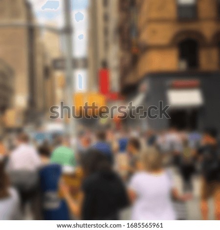 Blurred photo of people and building in city 