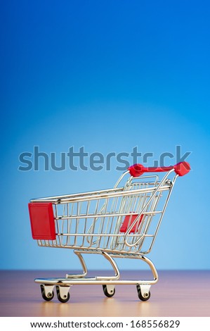 Mini shopping cart against gradient background