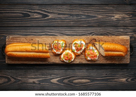 Smorrebrod or sandwich with Ricotta and salmon  on the cutting board. Top view