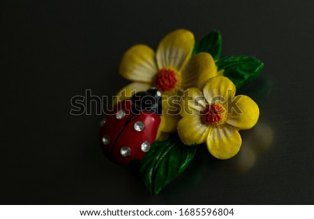 Refrigerator magnet ladybug on yellow flowers