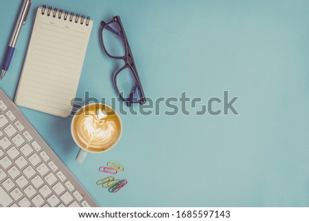 Office business desk table blank notepad with pen , coffee and eye glasses,keyboard coputer stay home. Top view with copy space