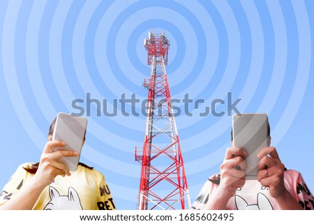 A girl holding a smartphone and background is a telephone pole.