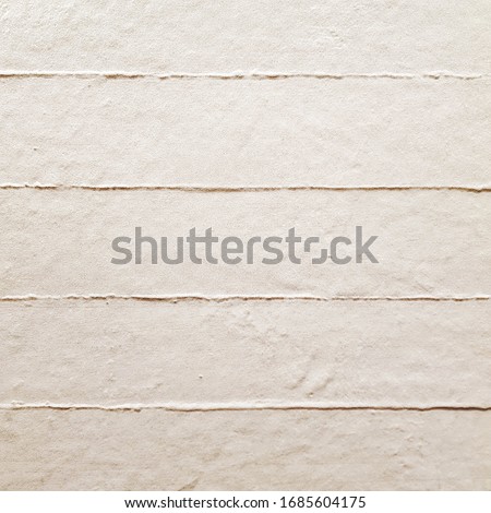 White ceramic tile with geometric pattern for wall and floor decoration. Concrete stone surface background. Texture with horizontal lines ornament for interior design. 