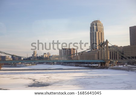 The Carlyle Building seen behind the Hennepin Avenue Bridge in Winter