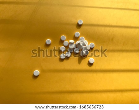 Vitamins and doctor s mask, corona virus protection concept on yellow background. Respiratory medical mask and pills. Coronavirus, hospital or environmental pollution protects face masking