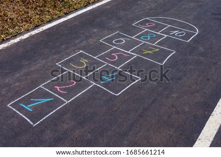 Hopscotch game drawn with chalk on the asphalt