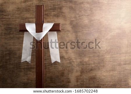 Christian cross in retro style on wooden background. Easter background. Peace symbol icon. Christian banner.