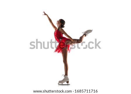 Girl figure skating isolated on white studio backgound with copyspace. Professional practicing and training in action and motion on ice. Graceful and weightless. Concept of movement, sport, beauty.