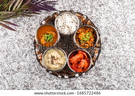 Traditional Indian dish Tali on a grey stone table, horizontally top view Royalty-Free Stock Photo #1685722486
