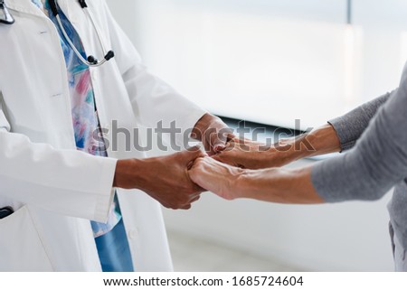 Hands of a doctor holding hands of elderly patient. Checking symptoms of stroke. Medical care and support concept. Royalty-Free Stock Photo #1685724604
