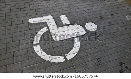 disabled parking tile sign in the city
