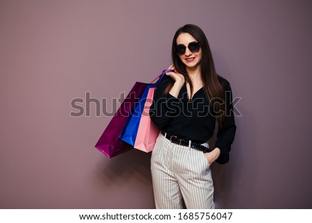 Young happy summer shopping woman with shopping bags isolated on background.
