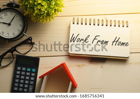 coronavirus conceptual. composition of office supplies on wooden desk with text WORK FROM HOME. flat lay Royalty-Free Stock Photo #1685756341
