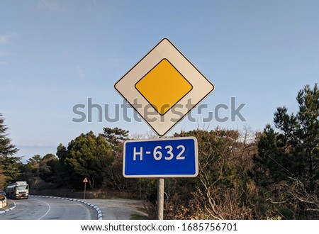 The traffic sign for the main road