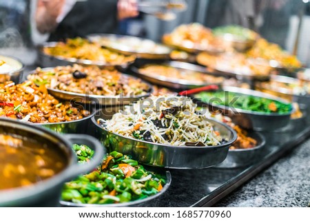 Traditional Asian dishes sold in a shopping mall food court in Singapore. Royalty-Free Stock Photo #1685770960