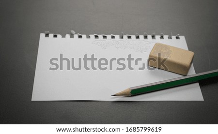Blank note paper with pencil
on blackboard, chalkboard black
