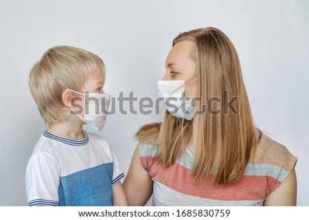 Woman and her son wearing medical masks protecting from coronavirus Royalty-Free Stock Photo #1685830759