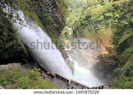 A gigantic waterfall called "Pailon del Diablo" and a rainbow above the base of the waterfall