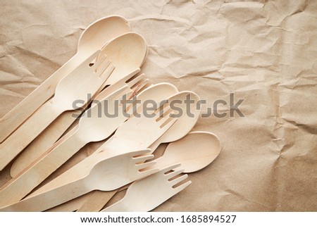 eco friendly disposable kitchenware utensils on paper background. look from above. wooden forks. eco friendly concept. copy space