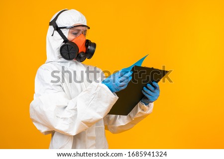 Epidemiologist in a respirator. Respirator on the face of a virologist. Concept - sale of clothing protecting against viruses. Clothing for the epidemiological laboratory. Concept - virologist career Royalty-Free Stock Photo #1685941324