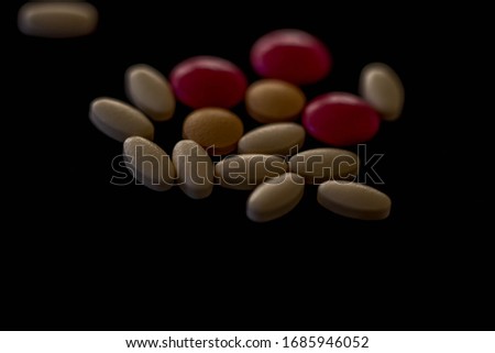 Top View Of Pile Of Different Types Of Pills And Tablets In Various Shapes And Colors Isolated On Dark Background