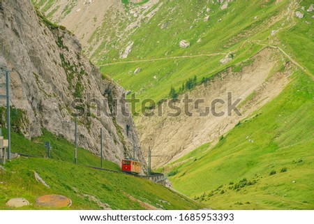 Awesome landscape with the red train over Mount Pilatus, Lucerne, Switzerland