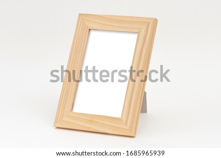 Wooden square photo frame on the gray background.