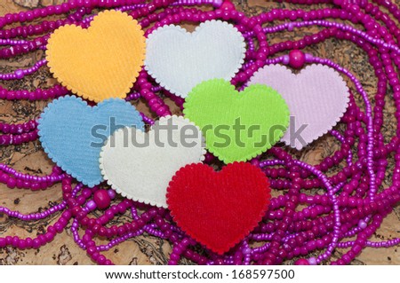 Photo with hearts. 7 hearts on pink beads and cork background. Can be used as a postcard for valentine's day.