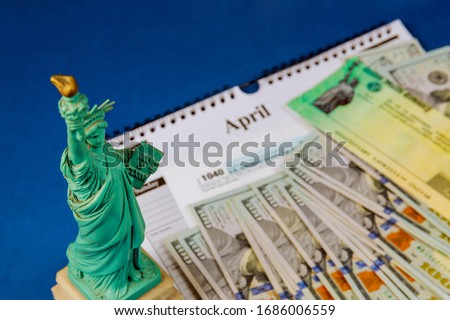 Money and calendar U.S dollars money tax return Statue Liberty in the tax period in the US with 1040 US tax form
