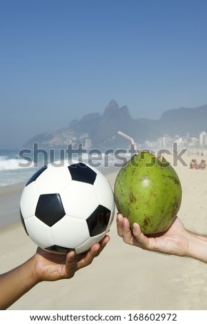 Fresh green drinking coconut coco gelado and football soccer ball Ipanema Beach Rio de Janeiro Brazil