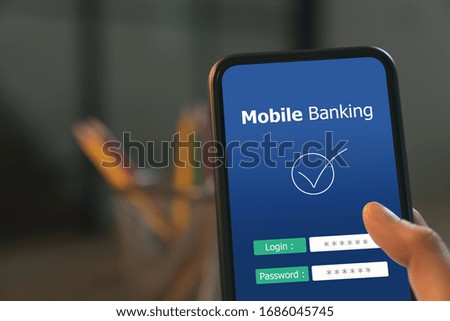 Hands press smartphone with login payment mobile banking online.