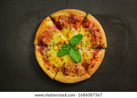 Top view of hot pizza cheese ,Tasty pizza cheese on black background.