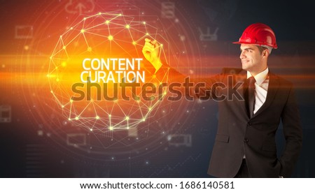 Handsome businessman with helmet drawing CONTENT CURATION inscription, social construction concept