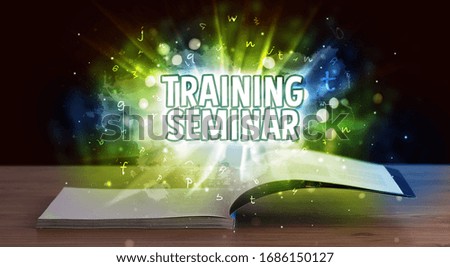 TRAINING SEMINAR inscription coming out from an open book, educational concept