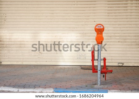A parking meter in front of a closed shop