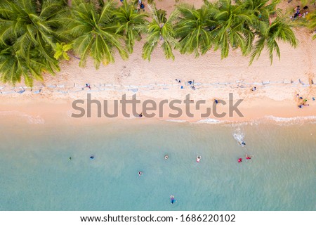 Beautiful beach with coconut trees and sea water And many people