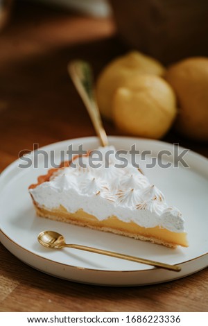 
Lemon tart on the counter top, meringue top
